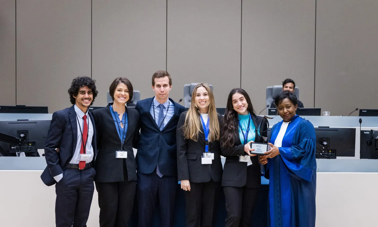 The winning team with a judge in the ICC courtroom at the Final of the 2023 English edition of the ICC Moot Court Competition